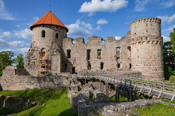 Fototapeta na wymiar View of beautiful ruins of ancient Livonian castle in old town of Cesis, Latvia. Greenery and summer daytime.