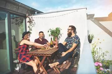 Bearded man with couple drinking wine on roof - obrazy, fototapety, plakaty