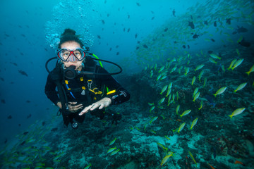 Woman scuba diver exploring sea bottom