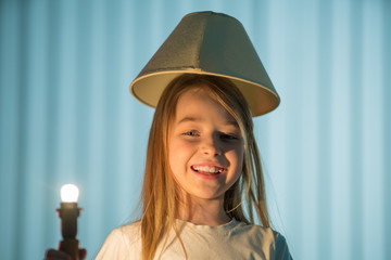 The smile girl on the background of a lamp
