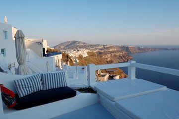 Piece of Mediterranean cruise On Santorini island, Greece. The view from the hotel on the lower terrace and the shore of the Aegean sea. characteristic architecture blue and white tones in the decor