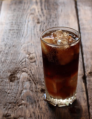 Fresh cold drink with ice on a wooden background