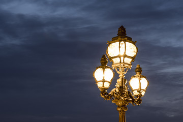 Fototapeta na wymiar Vintage lamp post at dusk, Paris