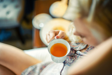 woman drinking tea in bed