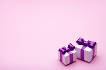 Gifts with satin bows on pink