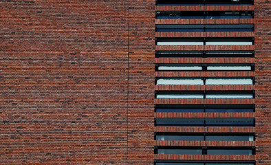 Brick wall pattern with windows. Brick wall background. Window pattern. Brick layers. Orange stone.