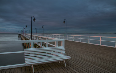 Wooden pier in Gdynia Orlowo in the morning with colors of sunrise. Poland. Europe.