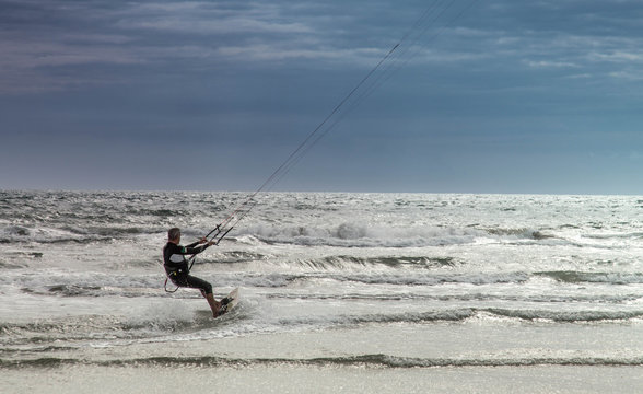 Kitesurf start on beach at sunset