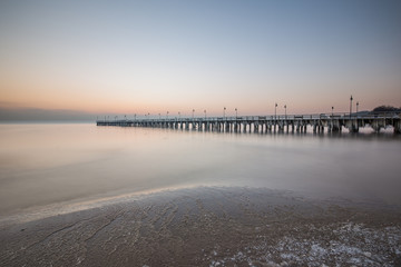 Winter scenery. Old pier in Gdynia Orlowo Poland with ice formations icicles. Frozen Sea Baltic...