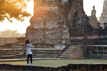 girl is taking photo of ancient temple