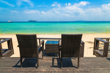Beach chairs on the white sand beach at summer terrace restaurant