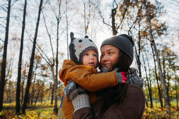 mother and daughter hugging in the park
