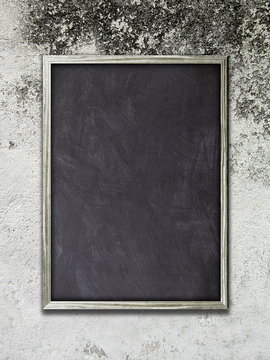 Single blank blackboard frame on gray wall