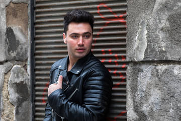 Obraz premium Handsome young man with black leather jacket