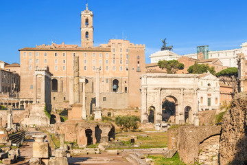 Rome, Italy. Roman Forum, from left to right: Saturn Temple (489 BC), Column of Phocas (608) Tabularium (Senators Palace), Arch of Septimius Severus (205 AD), Mamertinum