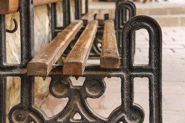 Old style bench with metal frame and wooden seat