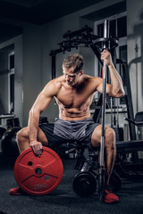 Fototapeta na wymiar Shirtless muscular male in a gym club.