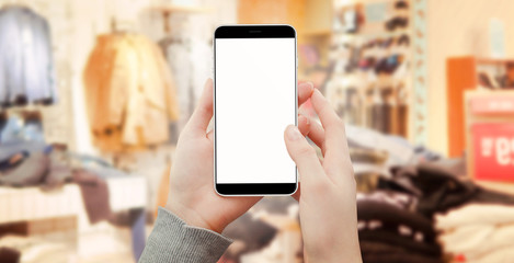 Women holding smartphone in boutique shopping online