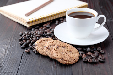Coffee cup and coffee beans on wooden background