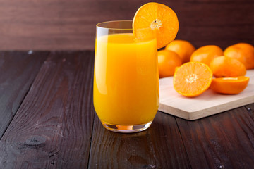 Orange juice on wooden background