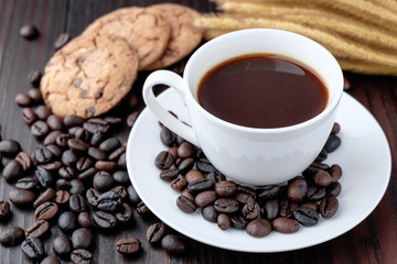 Coffee cup and coffee beans on wooden background