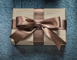 Present box on black background holidays concept