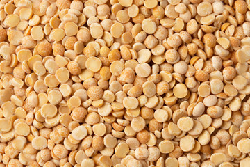 yellow raw organic split peas texture background. Close up grain.