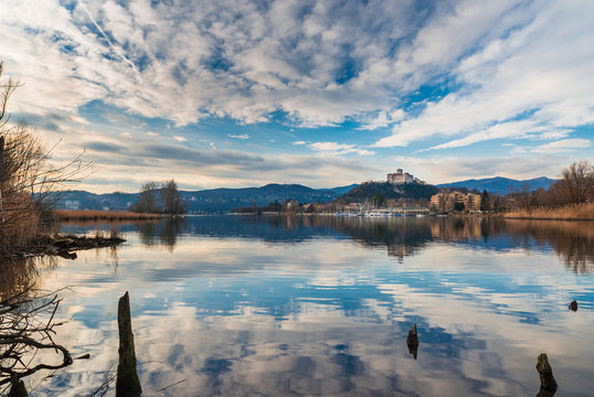 Lake Maggiore, panorama of the small village of Angera, the medieval fortress Borromea and nature reserve Bruschera, Italy