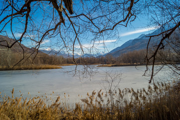 mountain panorama, with frozen lake, trees and forest