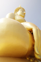 angle under right side of huge golden buddha statue in thailand,with soft light