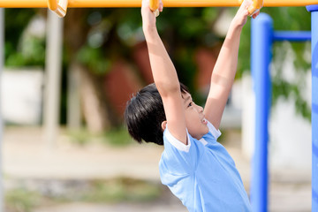 Fototapeta premium Young boy play with yellow bar
