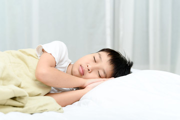 Fototapeta na wymiar Boy sleep on bed