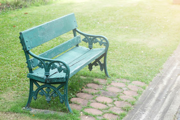 single green chair in the public park with orange light