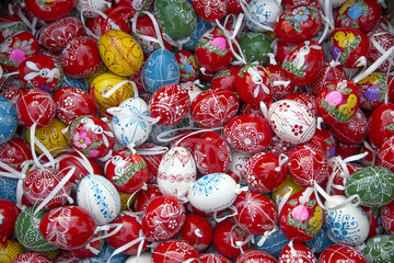 Fototapeta na wymiar Heap of many colorful hand painted homemade easter eggs on retail market for celebrating easter events