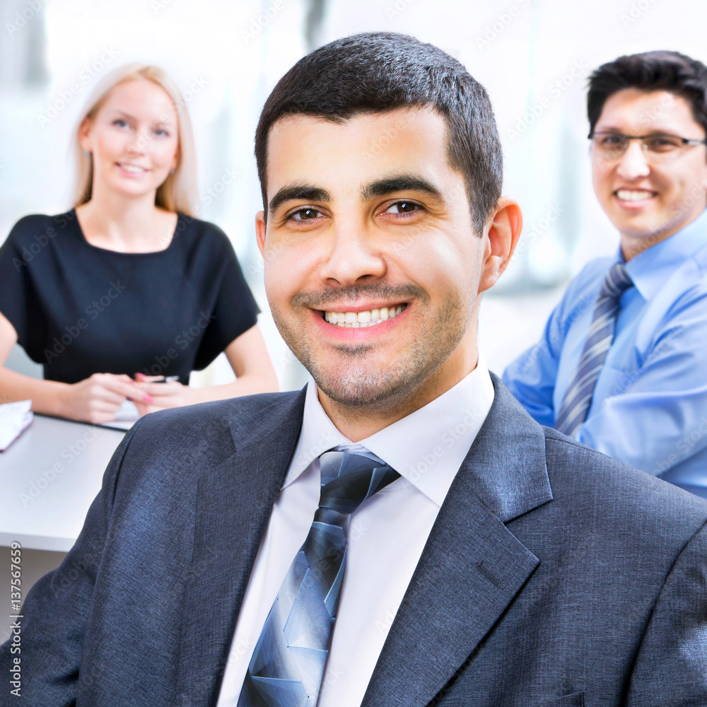 Wall mural Business man with colleagues