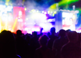 Fototapeta na wymiar Blurred Youth Music Festival of pop music. Laser show on the stage. The crowd of fans. Bright abstract background ideal for any design. Blurred bokeh basic background for design 