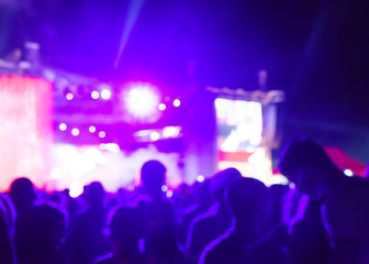 Fototapeta na wymiar Blurred Youth Music Festival of pop music. Laser show on the stage. The crowd of fans. Bright abstract background ideal for any design. Blurred bokeh basic background for design 