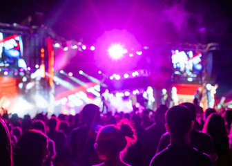 Naklejka na ściany i meble Blurred Youth Music Festival of pop music. Laser show on the stage. The crowd of fans. Bright abstract background ideal for any design. Blurred bokeh basic background for design 