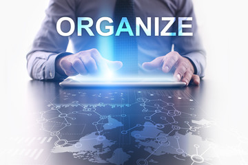 Businessman is using tablet pc and selecting organize.