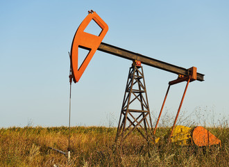Oil rig working on a golden sunset