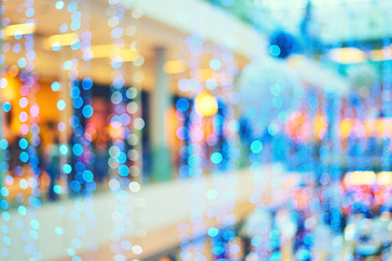 Bright blue Christmas garlands for decorations in the lobby of the mall. Blurred bokeh basic background for design