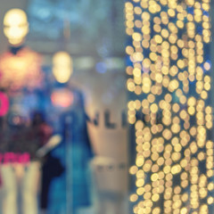 Blurred showcases fashion boutique with clothes.Big sales on Black Friday for Christmas.  Blurred bokeh basic background for design