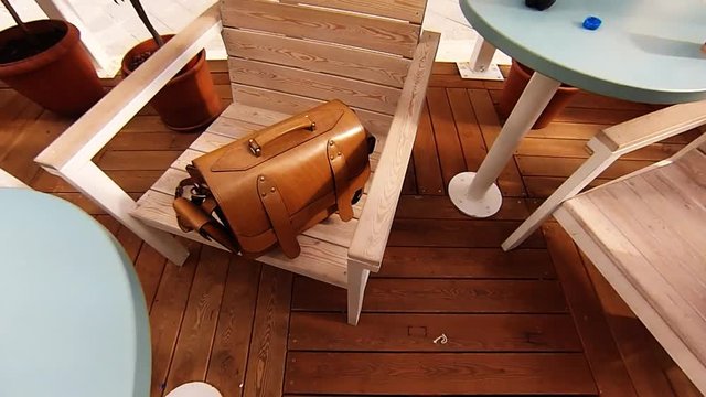 Outdoor caffee interior with chess board, violin, man bags