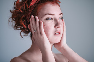 Fototapeta premium Young woman looking worried by the window