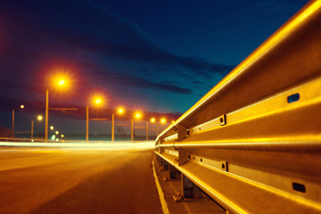 Blurred background with lights of the city at night. Big city bridge. Bokeh basic background for...