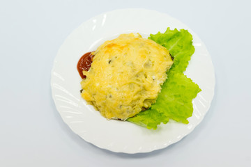 Recipe for European cuisine - pork chop with potatoes and mushrooms baked with cheese.