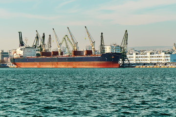 Fototapeta premium Evening panorama of the cargo port. Loading and unloading of ships