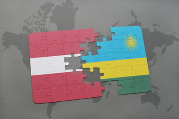 puzzle with the national flag of latvia and rwanda on a world map