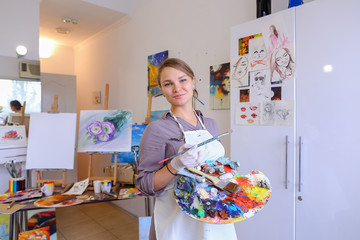 Women beautiful painter posing and smiling, laughing into camera