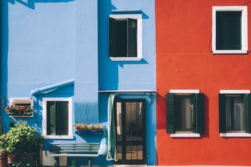 Beautiful Burano island colorful (red and blue) house wall facade